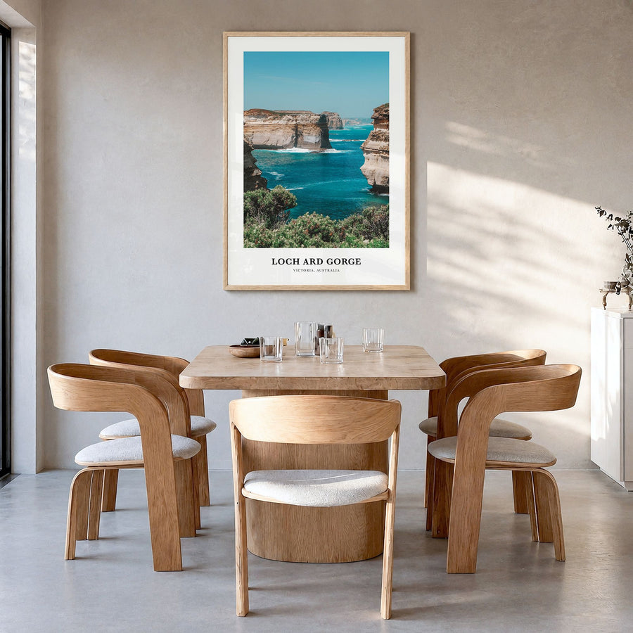 Loch Ard Gorge Classic Poster in a natural wood frame, hanging in a dining room