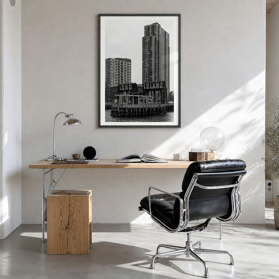 Long Island City Photo Poster in a black wood frame, hanging in a bright home office, white border