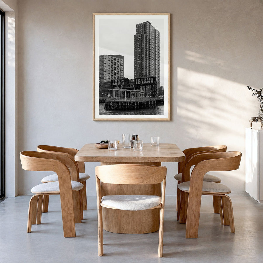Long Island City Photo Poster in a natural wood frame, hanging in a dining room, white border