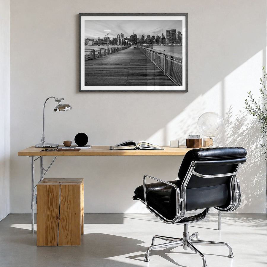Long Island Photo Poster in a black wood frame, hanging in a bright home office, white border