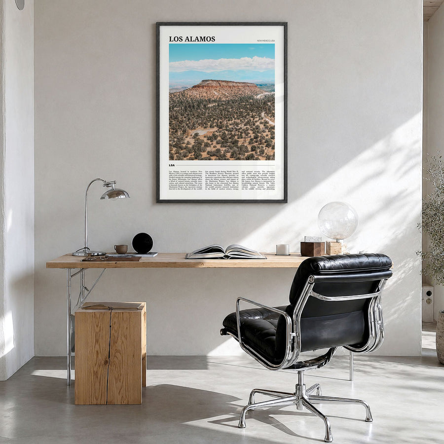 Los Alamos Travel Poster in a black wood frame, hanging in a bright home office