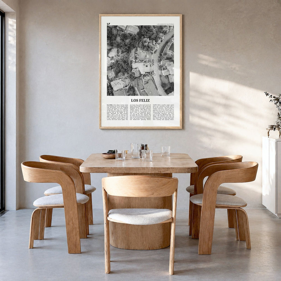 Los Feliz Newspaper Poster in a natural wood frame, hanging in a dining room