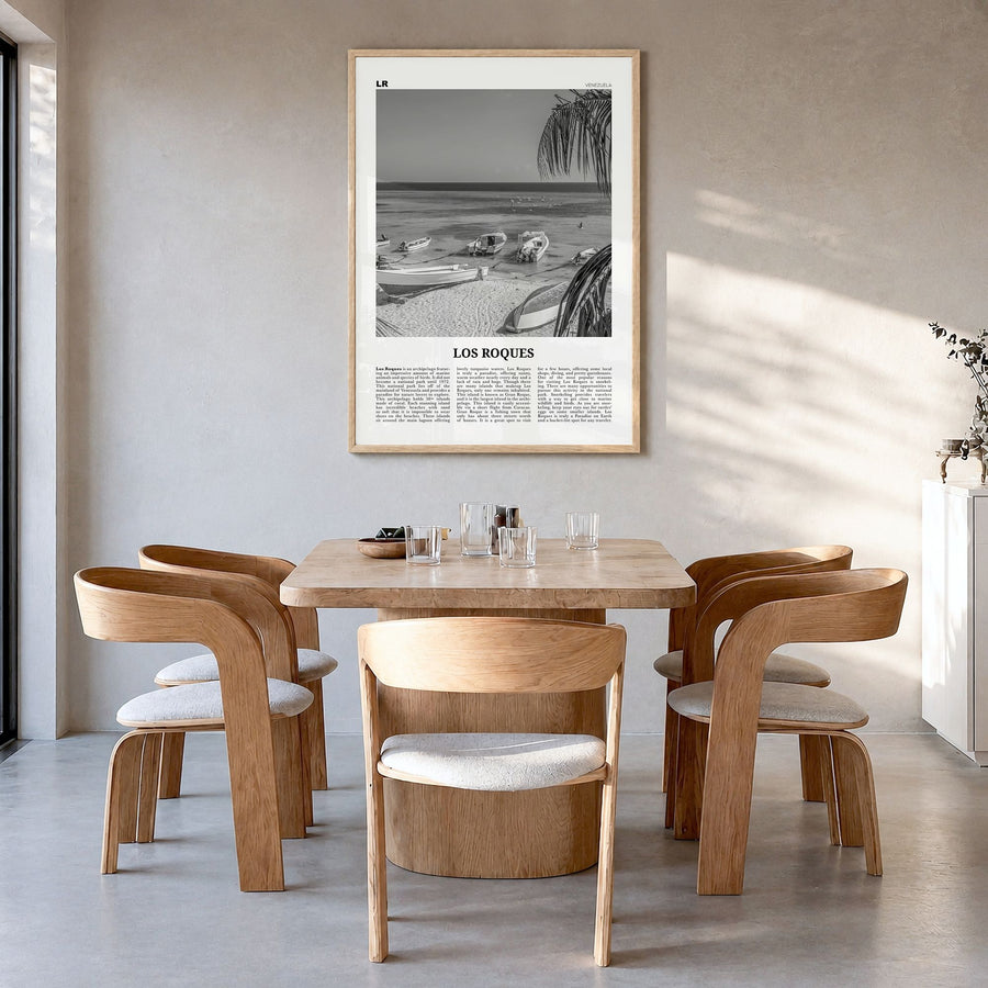 Los Roques Newspaper Poster in a natural wood frame, hanging in a dining room