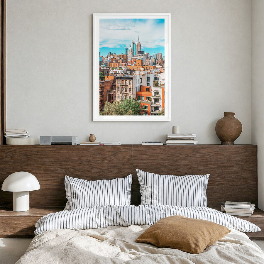 Lower East Side Photo Poster in a white wood frame, hanging in a bedroom, white border