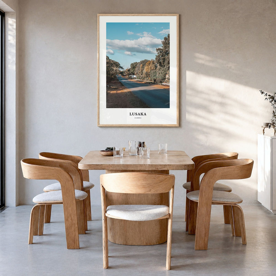 Lusaka Classic Poster in a natural wood frame, hanging in a dining room