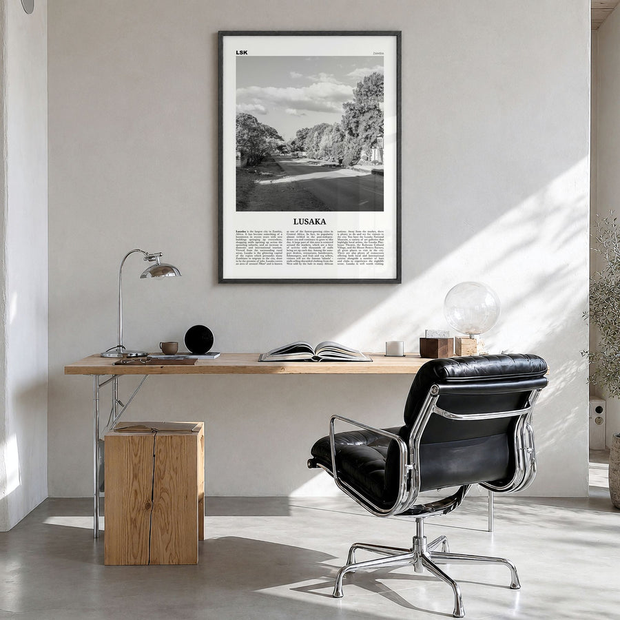 Lusaka Newspaper Poster in a black wood frame, hanging in a bright home office