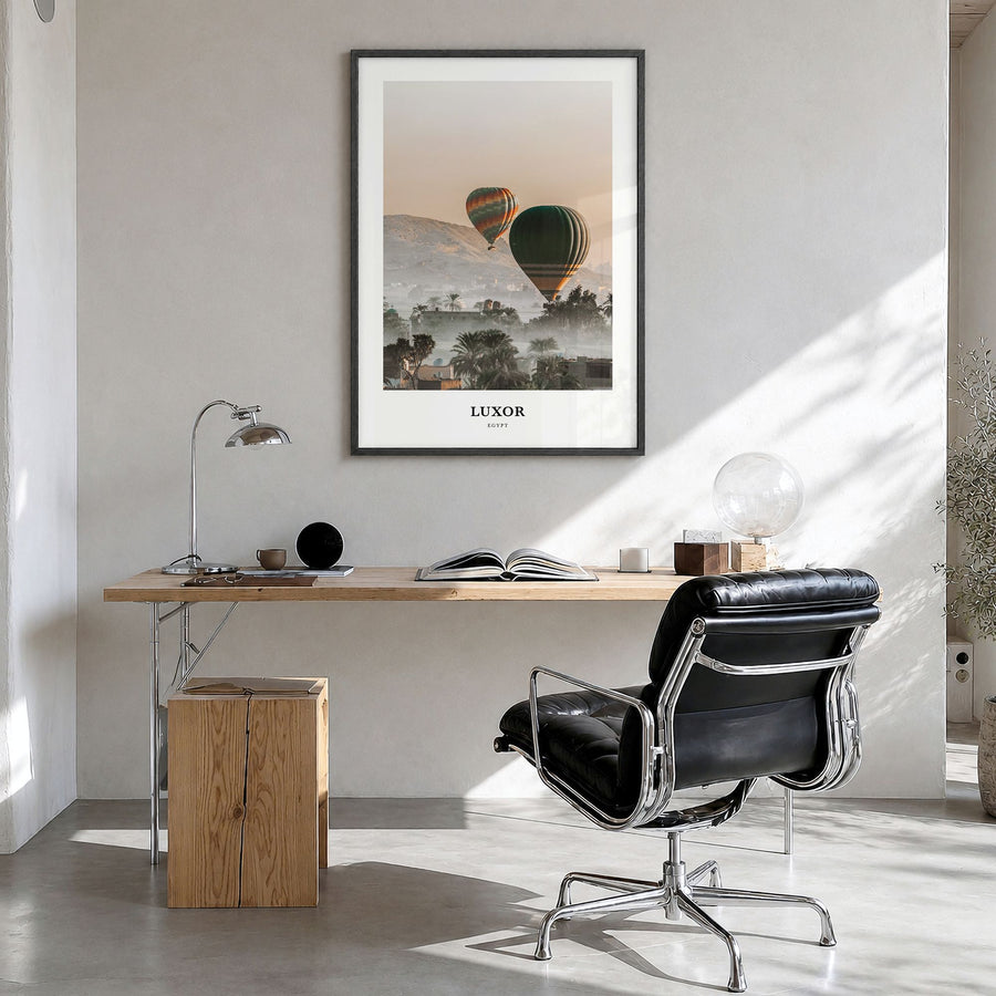 Luxor Classic Poster in a black wood frame, hanging in a bright home office