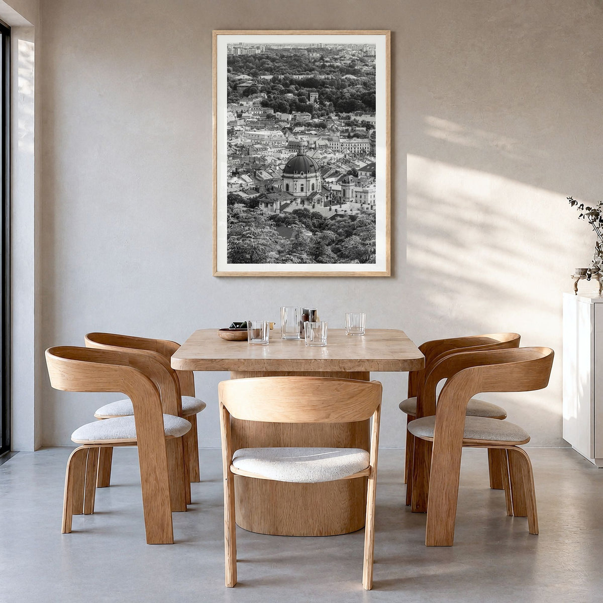 Lviv Photo Poster in a natural wood frame, hanging in a dining room, white border