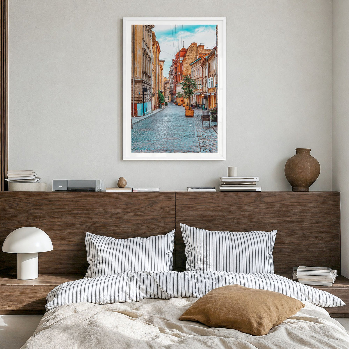 Lviv Photo Poster in a white wood frame, hanging in a bedroom, white border