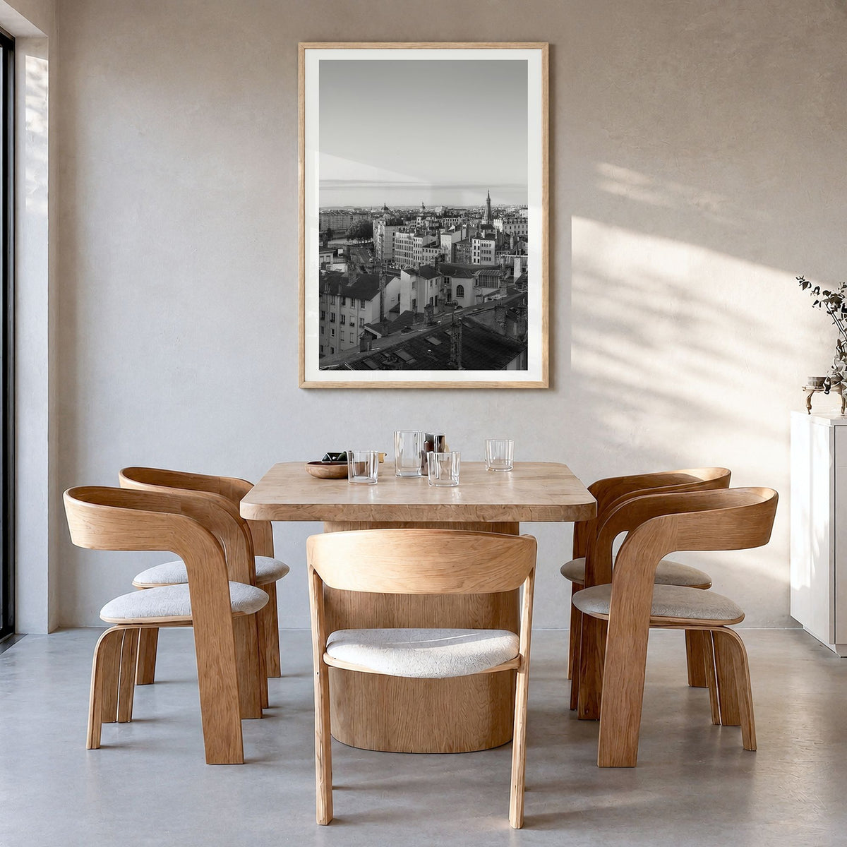 Lyon Photo Poster in a natural wood frame, hanging in a dining room, white border
