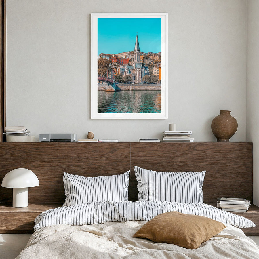 Lyon Photo Poster in a white wood frame, hanging in a bedroom, white border