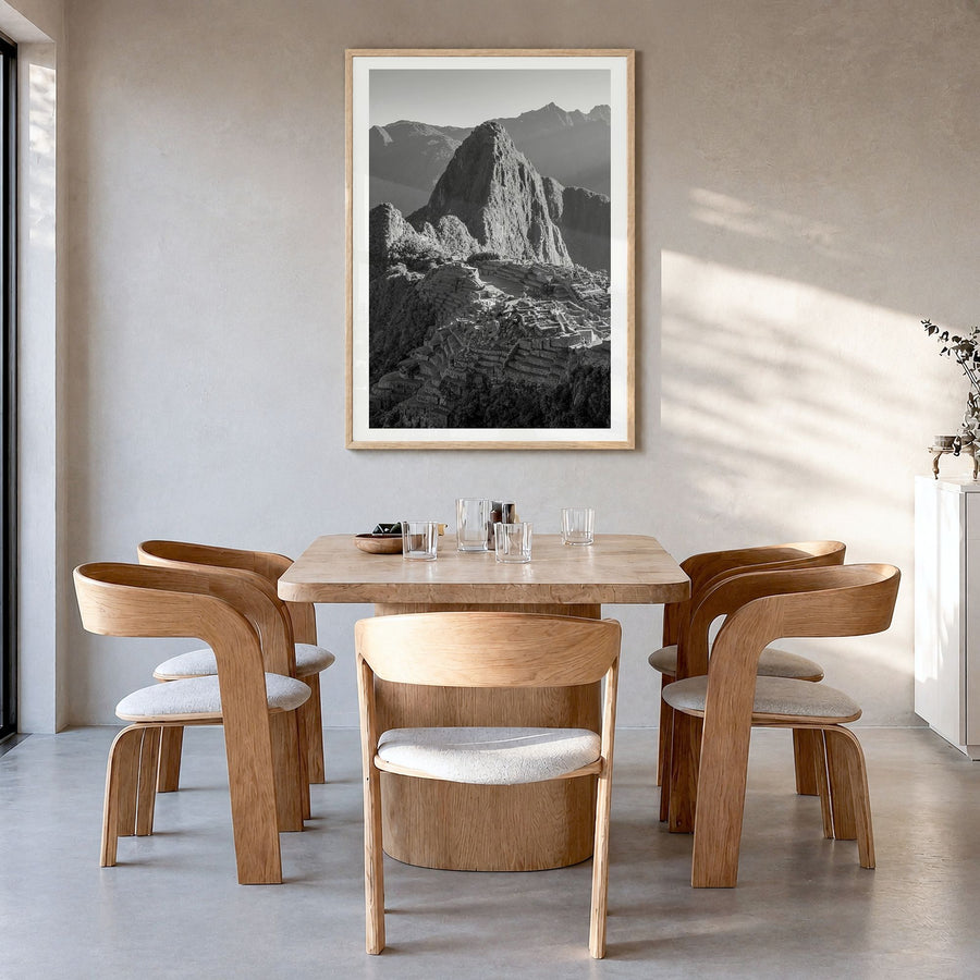 Machu Picchu Photo Poster in a natural wood frame, hanging in a dining room, white border