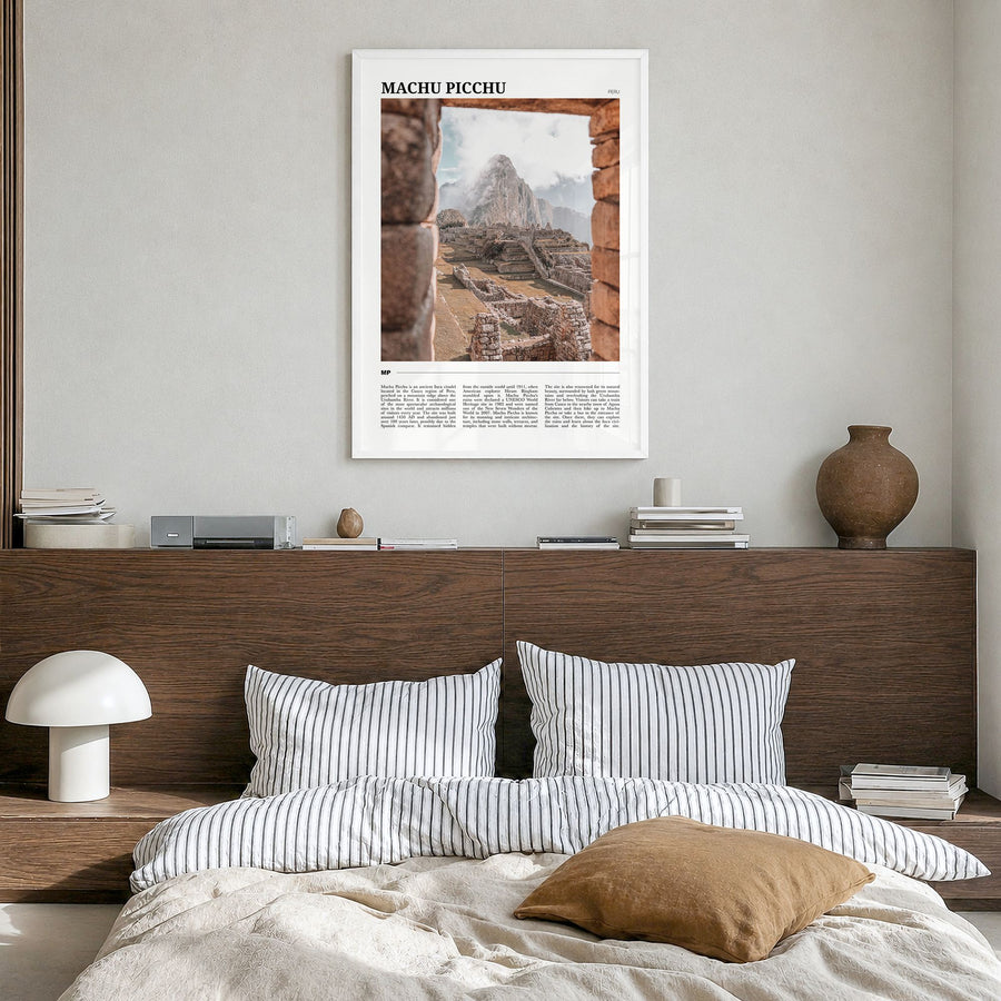 Machu Picchu Travel Poster in a white wood frame, hanging in a bedroom