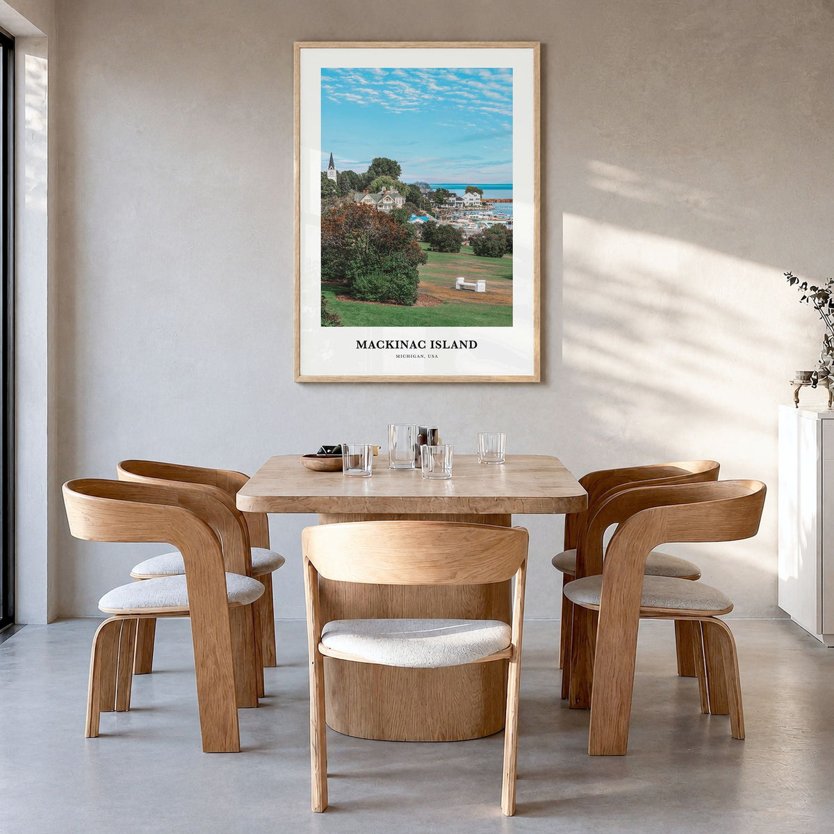 Mackinac Island Classic Poster in a natural wood frame, hanging in a dining room