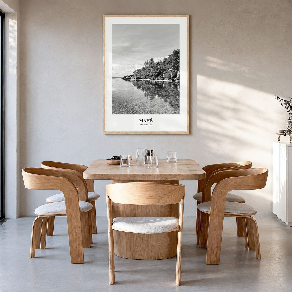 Mahé Classic Poster in a natural wood frame, hanging in a dining room