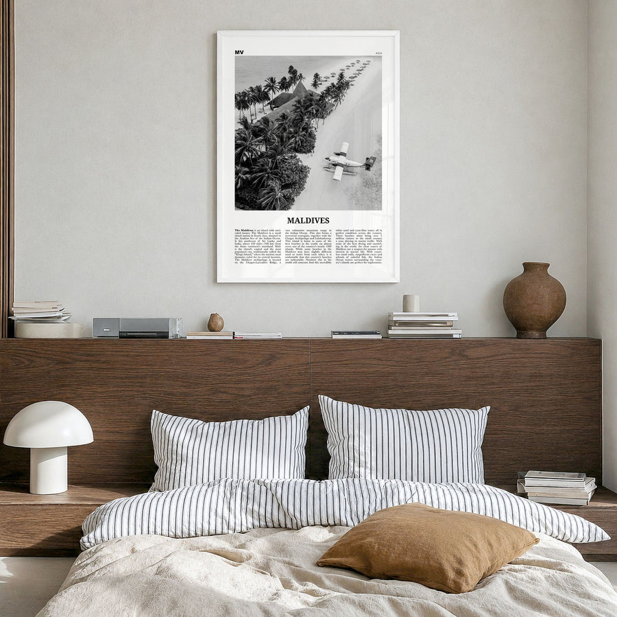 Maldives Newspaper No 3 Poster in a white wood frame, hanging in a bedroom