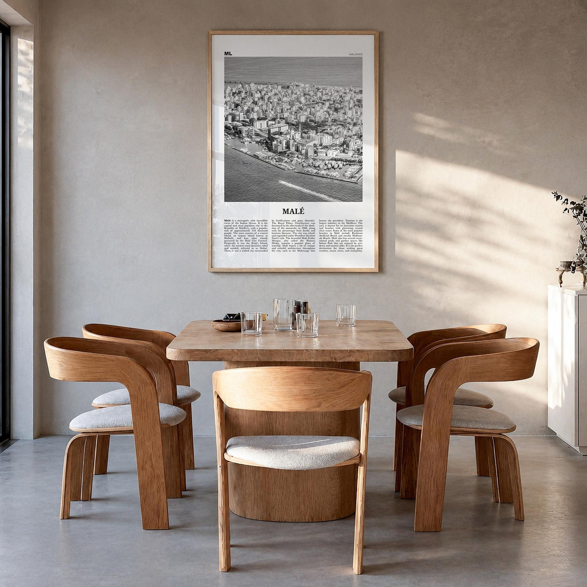 Malé black & white newspaper poster of Maldives – vertical wall art in natural wood frame, hanging on wall
