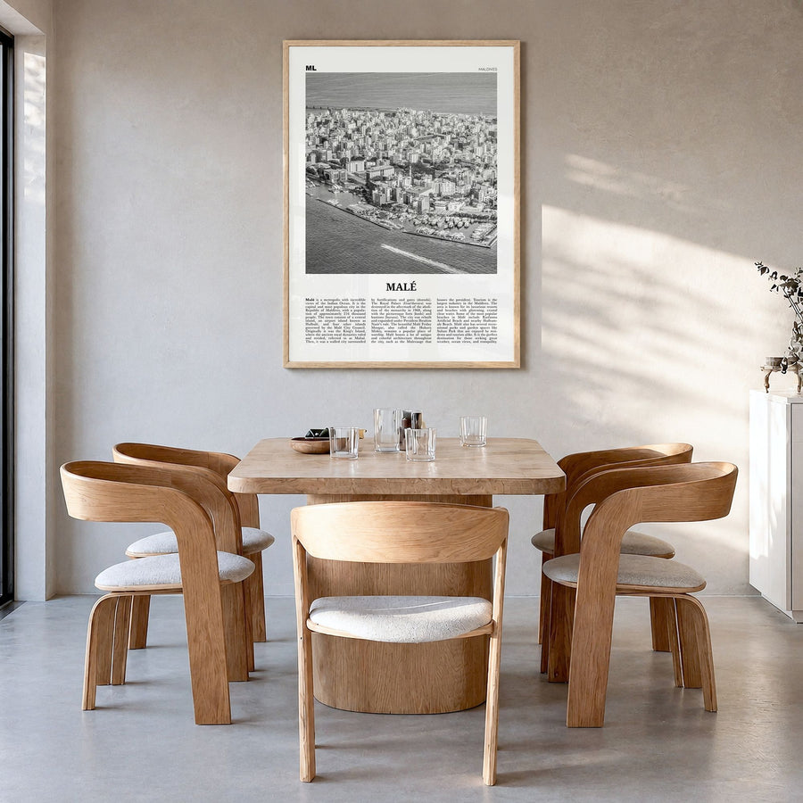 Malé Newspaper Poster in a natural wood frame, hanging in a dining room