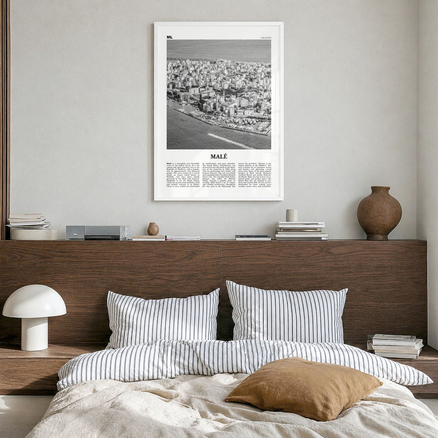Malé Newspaper Poster in a white wood frame, hanging in a bedroom