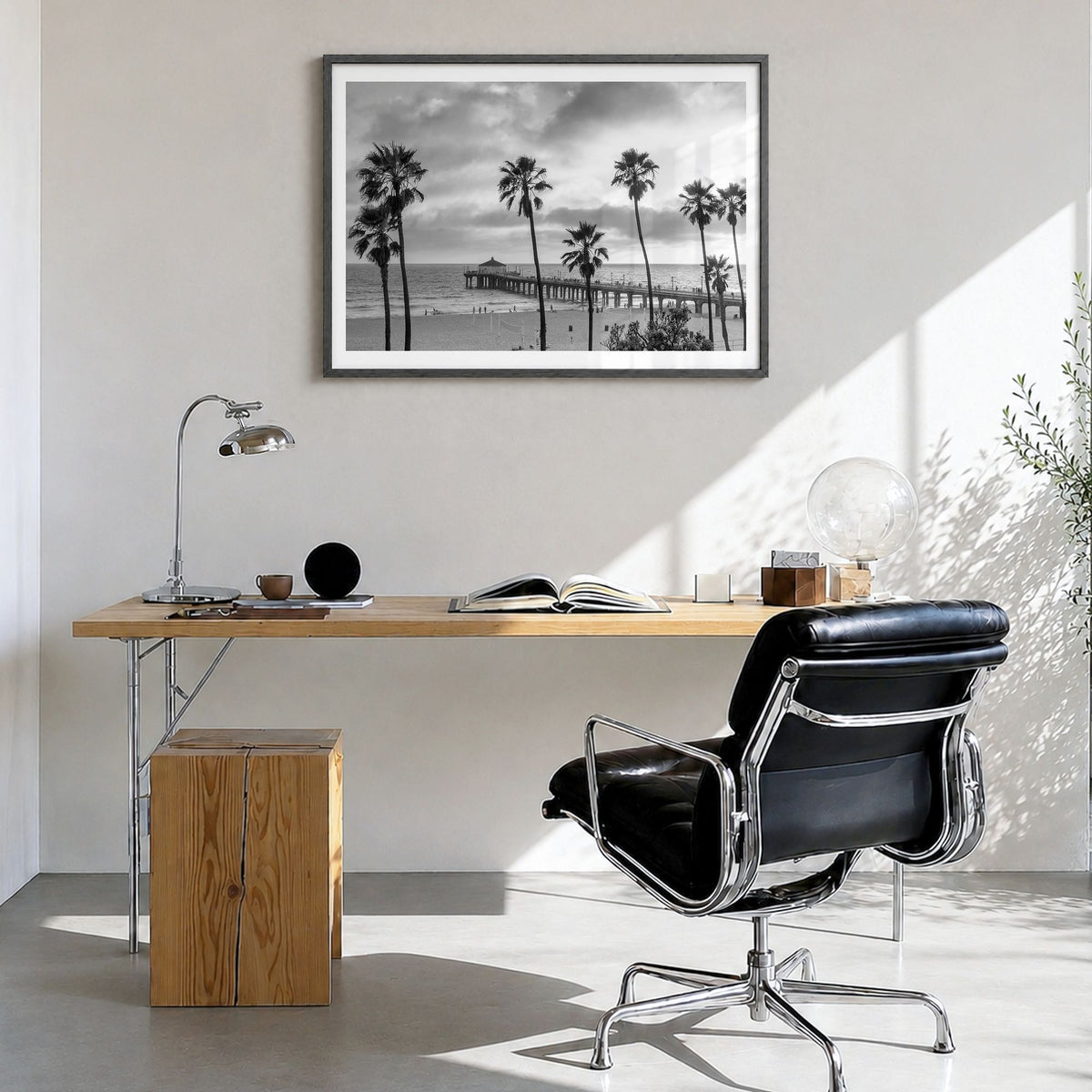 Malibu Photo Poster in a black wood frame, hanging in a bright home office, white border