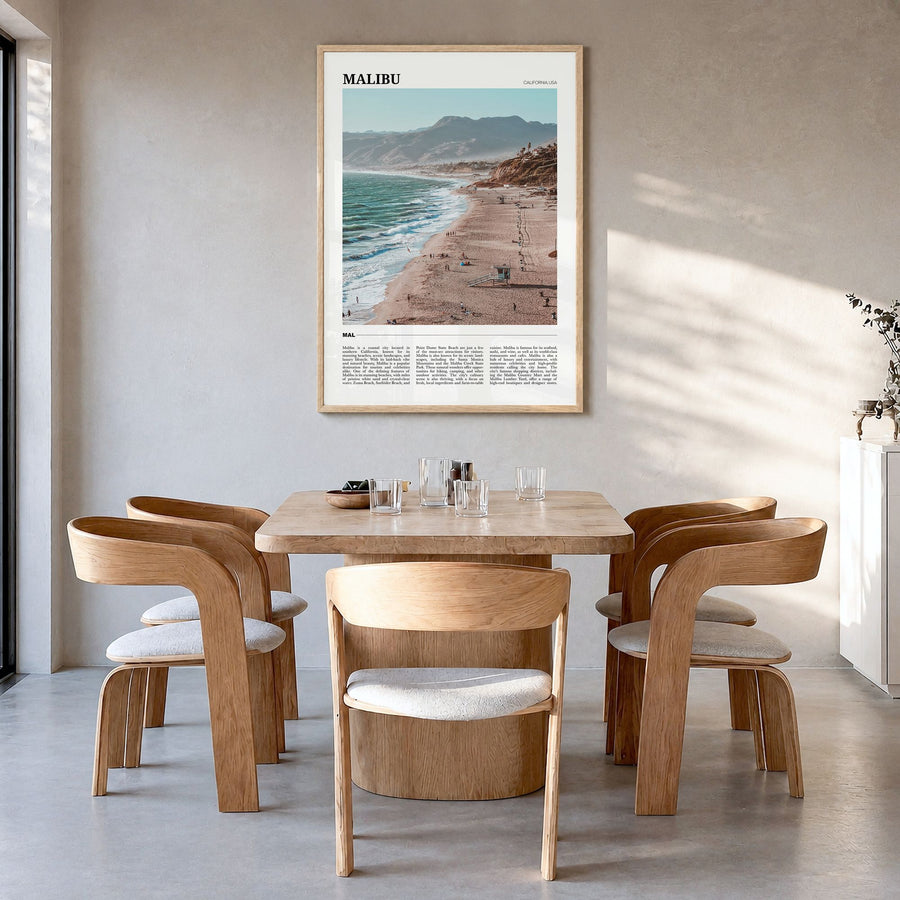 Malibu Travel Poster in a natural wood frame, hanging in a dining room