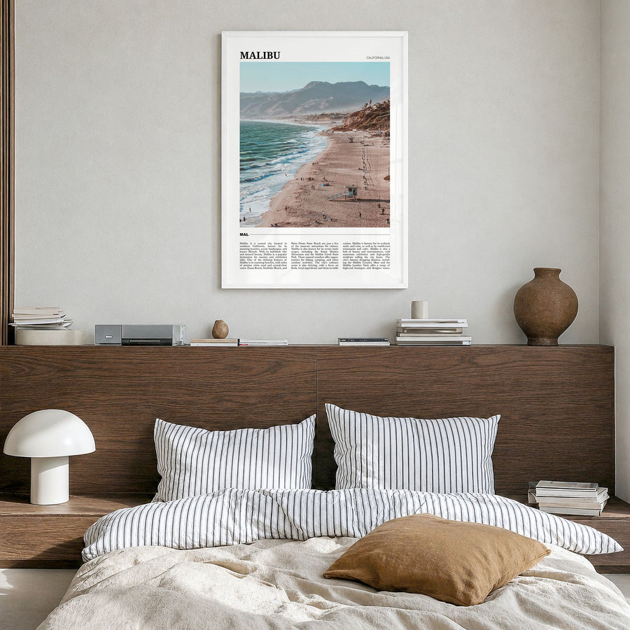 Malibu Travel Poster in a white wood frame, hanging in a bedroom