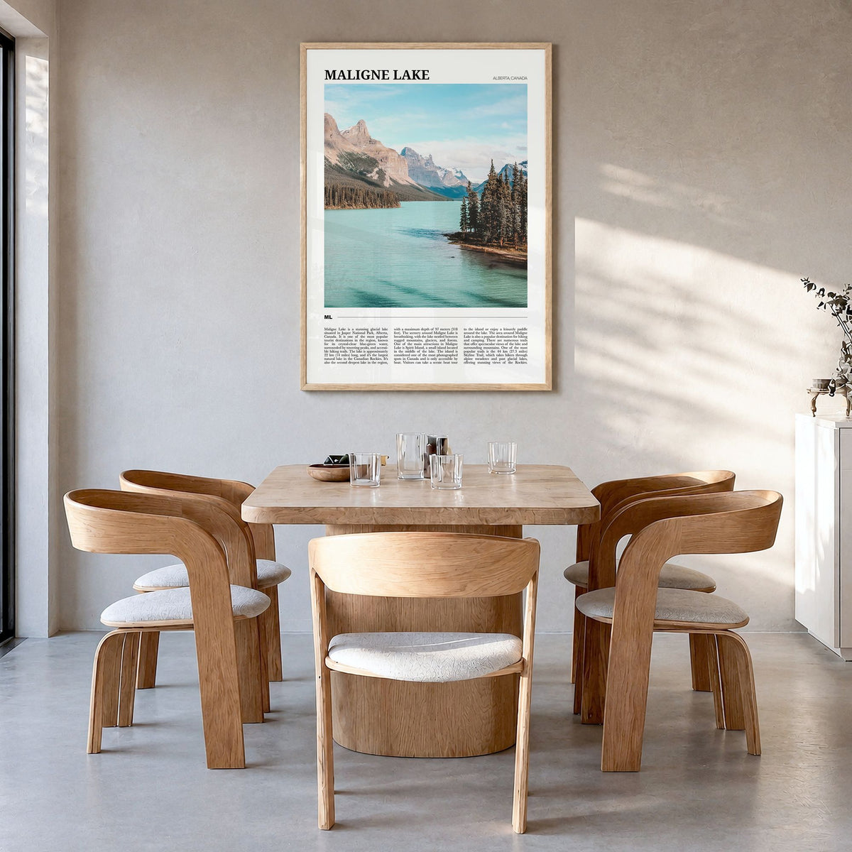 Maligne Lake Travel Poster in a natural wood frame, hanging in a dining room