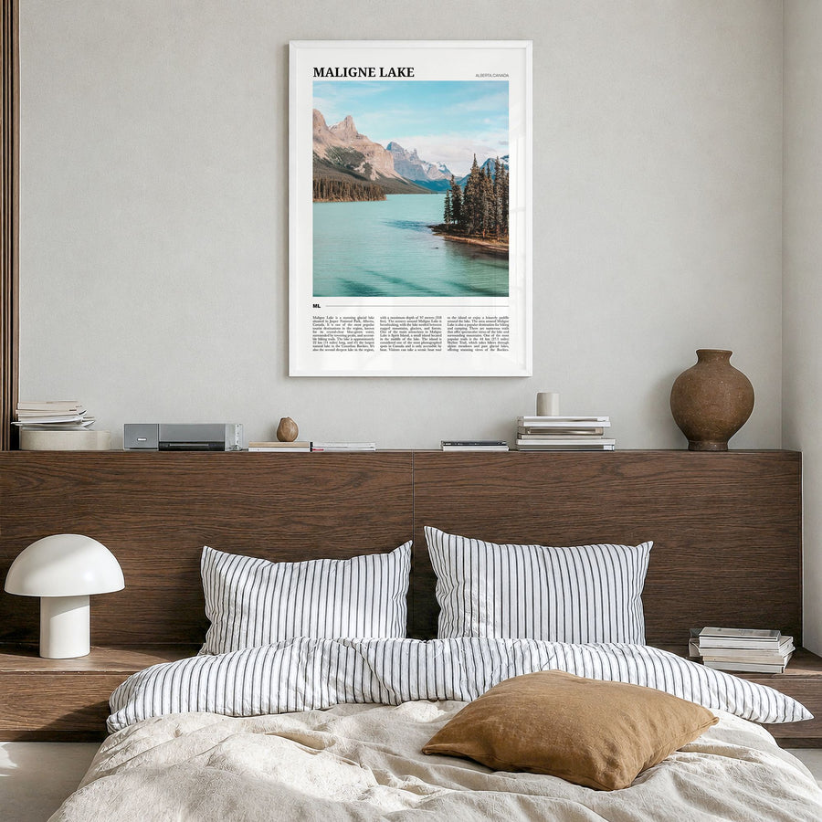 Maligne Lake Travel Poster in a white wood frame, hanging in a bedroom