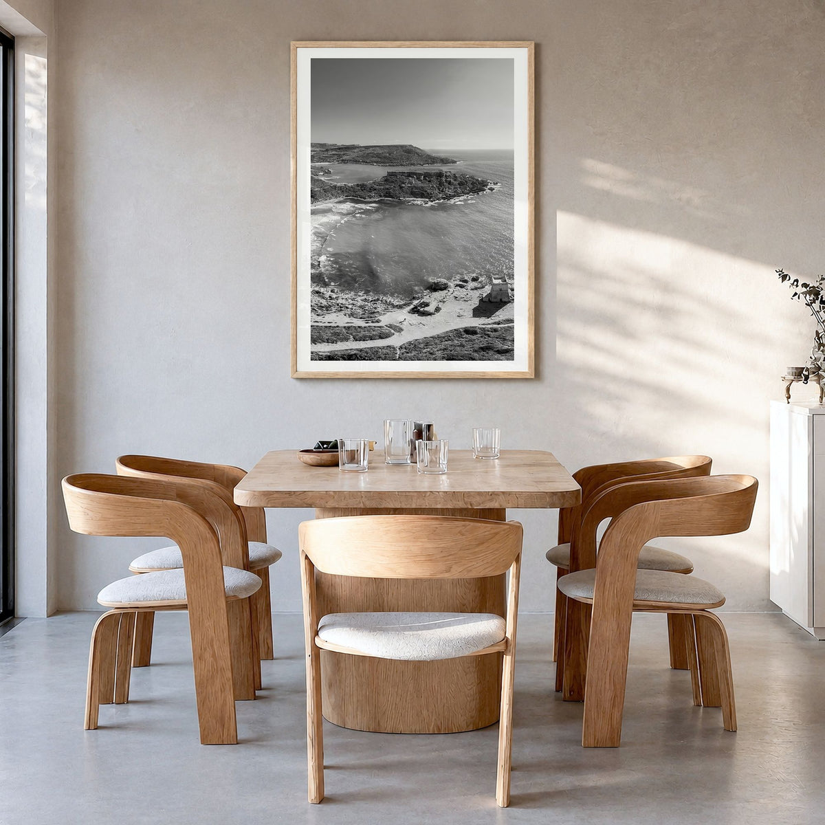 Malta Photo Poster in a natural wood frame, hanging in a dining room, white border