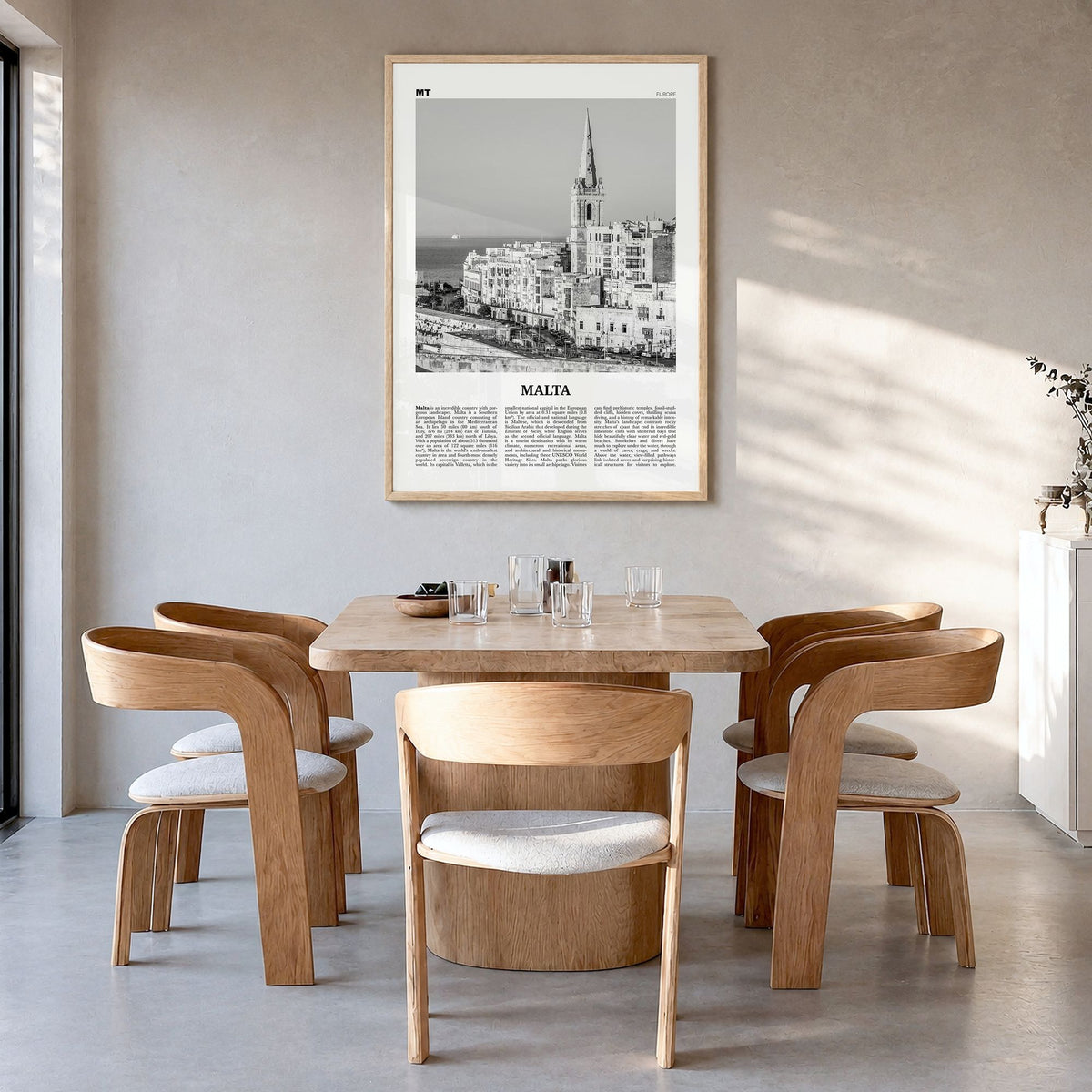 Malta Newspaper Poster in a natural wood frame, hanging in a dining room