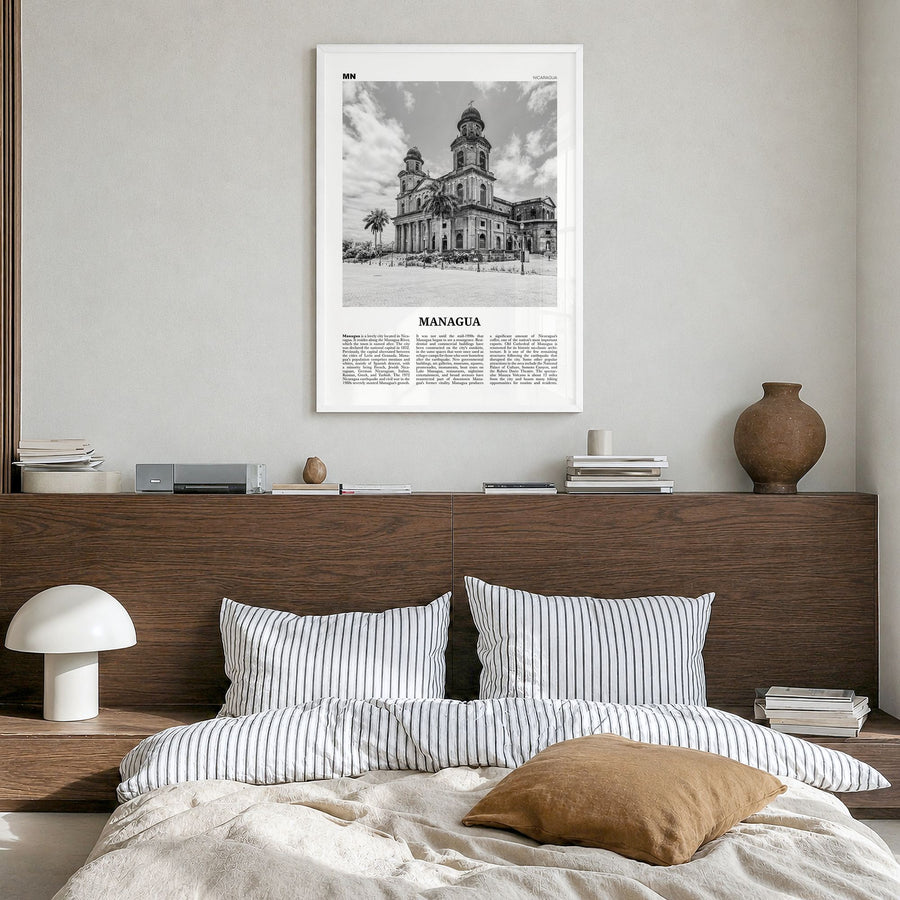 Managua Newspaper Poster in a white wood frame, hanging in a bedroom
