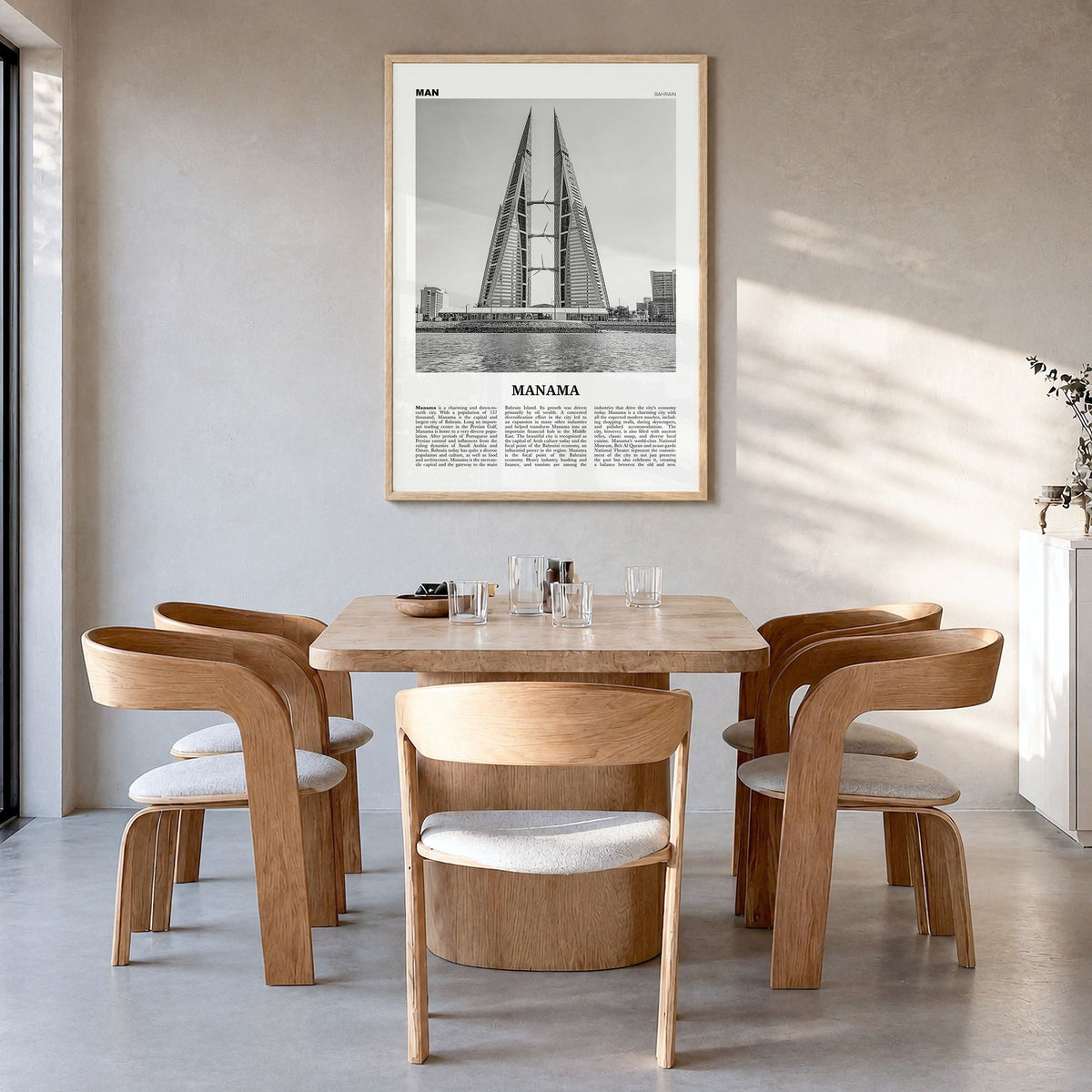Manama Newspaper Poster in a natural wood frame, hanging in a dining room