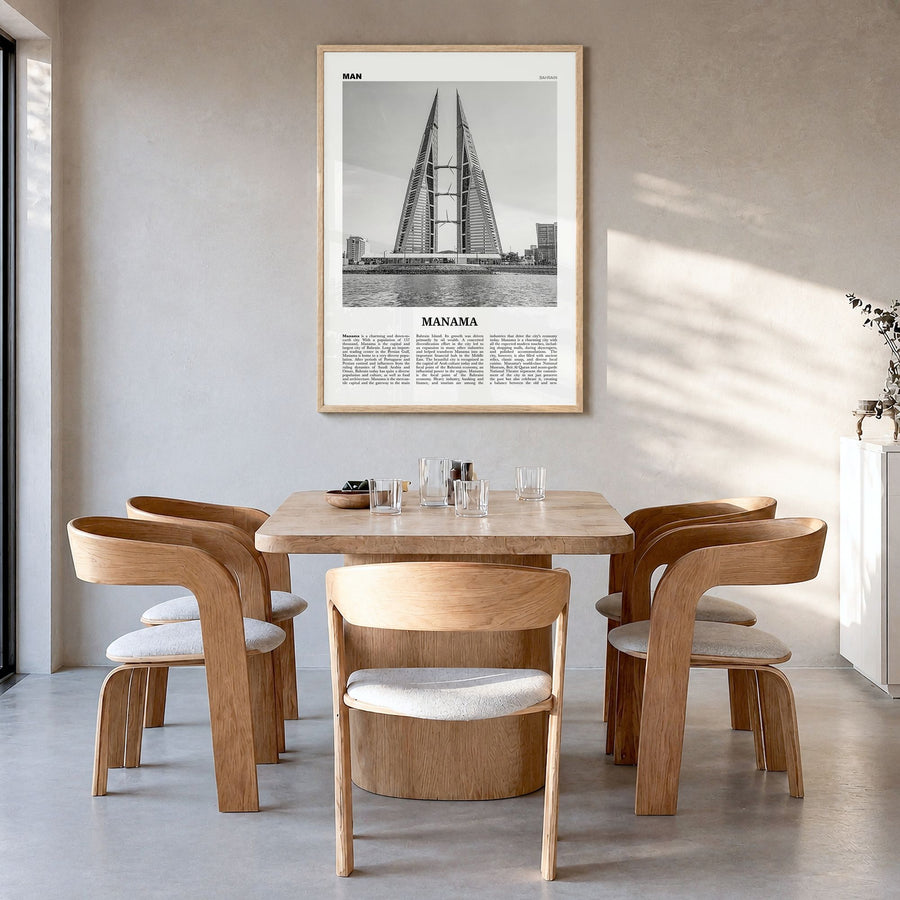 Manama Newspaper Poster in a natural wood frame, hanging in a dining room