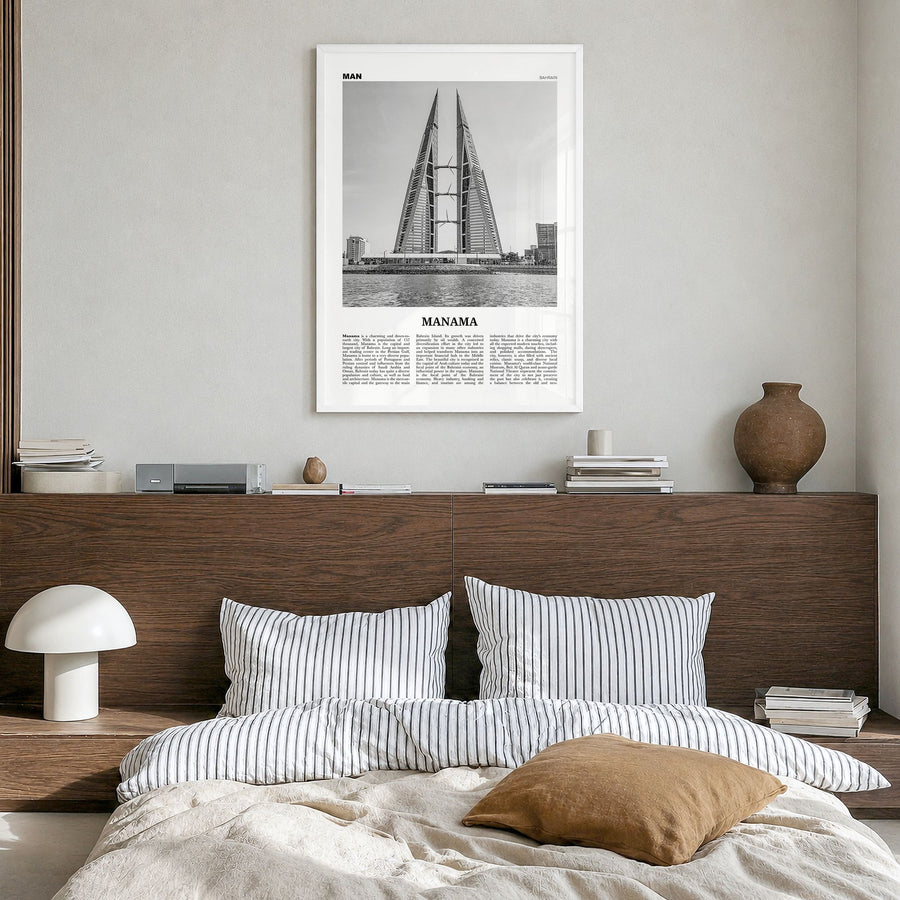 Manama Newspaper Poster in a white wood frame, hanging in a bedroom