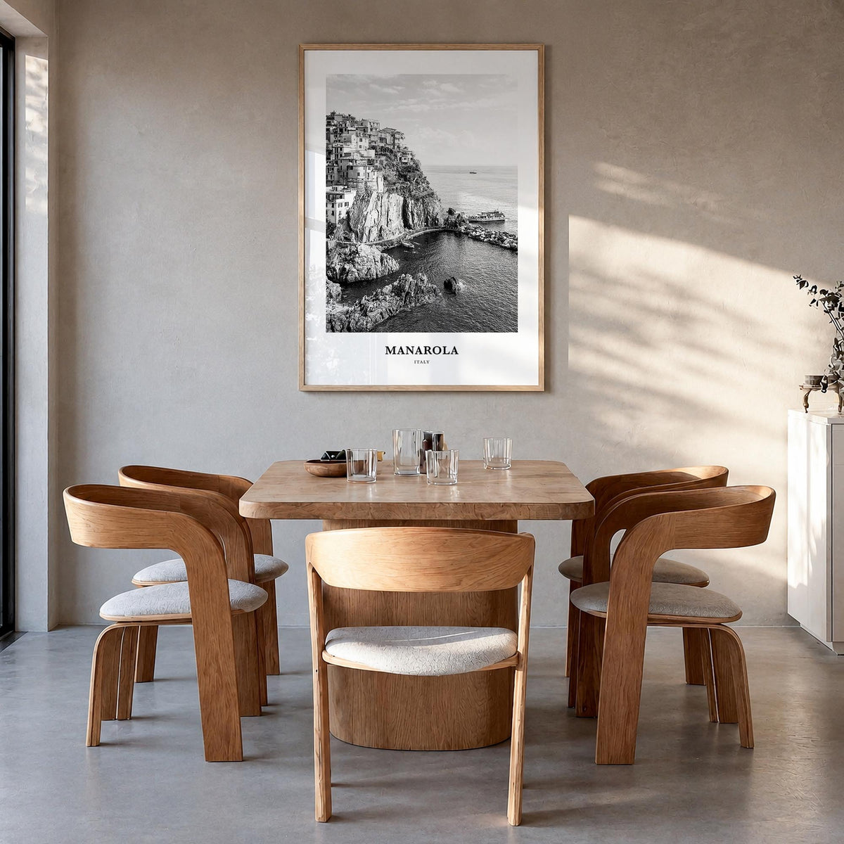 Manarola black & white classic poster of Italy – vertical wall art in natural wood frame, hanging on wall