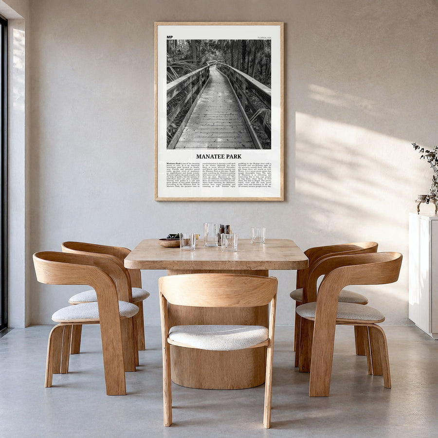 Manatee Park Newspaper Poster in a natural wood frame, hanging in a dining room
