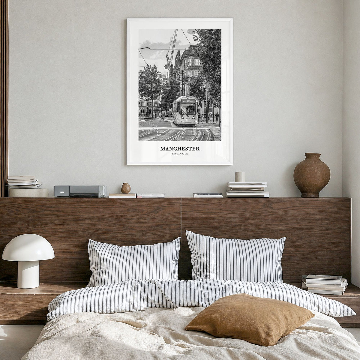 Manchester, England Classic No 1 Poster in a white wood frame, hanging in a bedroom