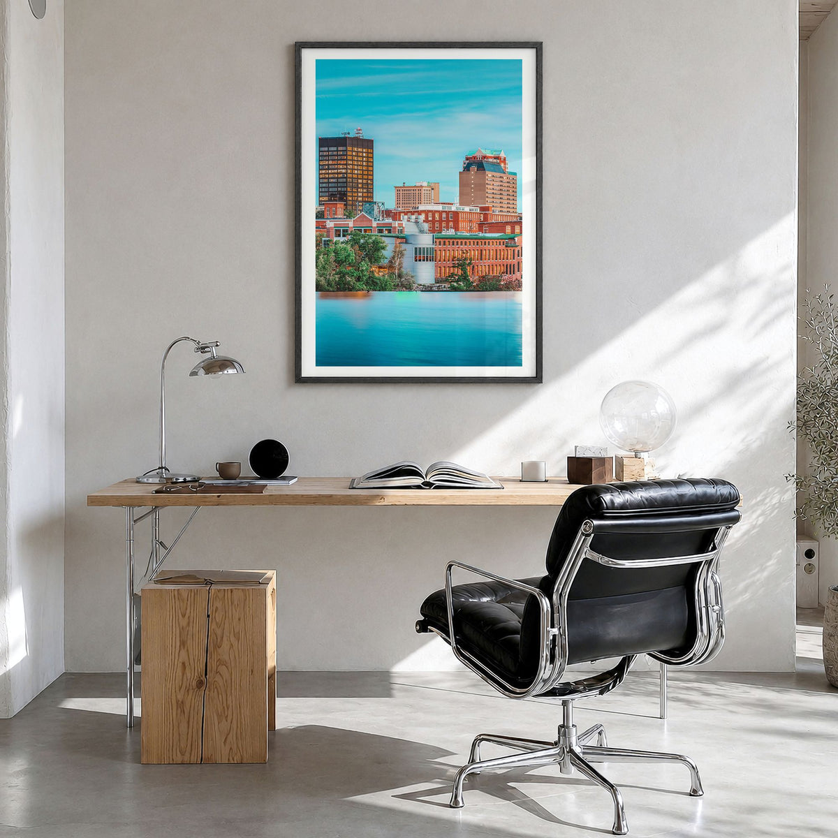 Manchester, New Hampshire Photo Poster in a black wood frame, hanging in a bright home office, white border