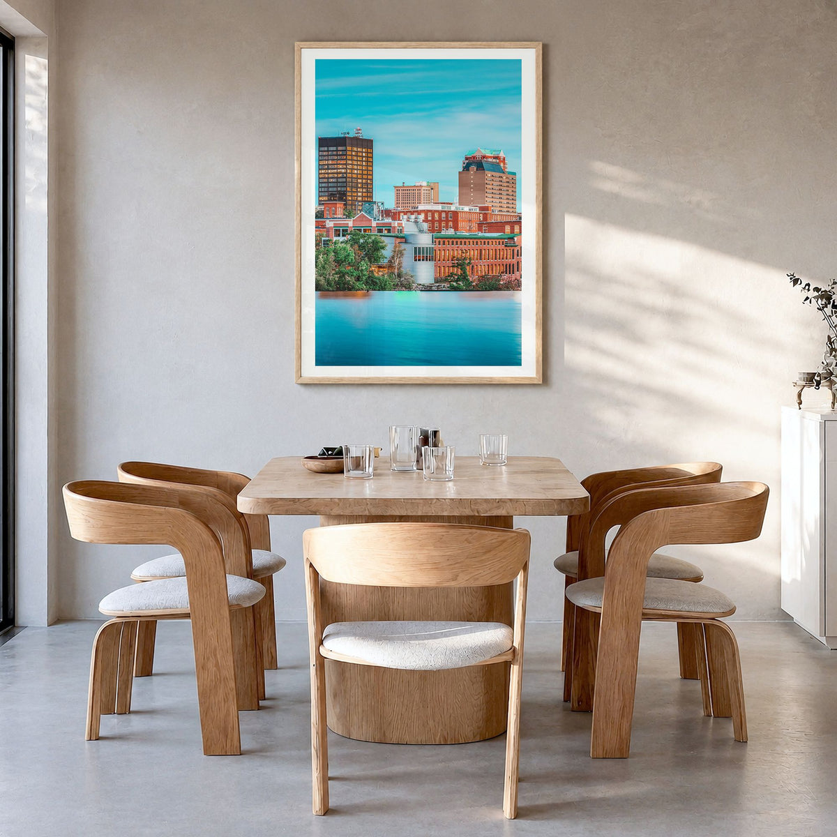 Manchester, New Hampshire Photo Poster in a natural wood frame, hanging in a dining room, white border