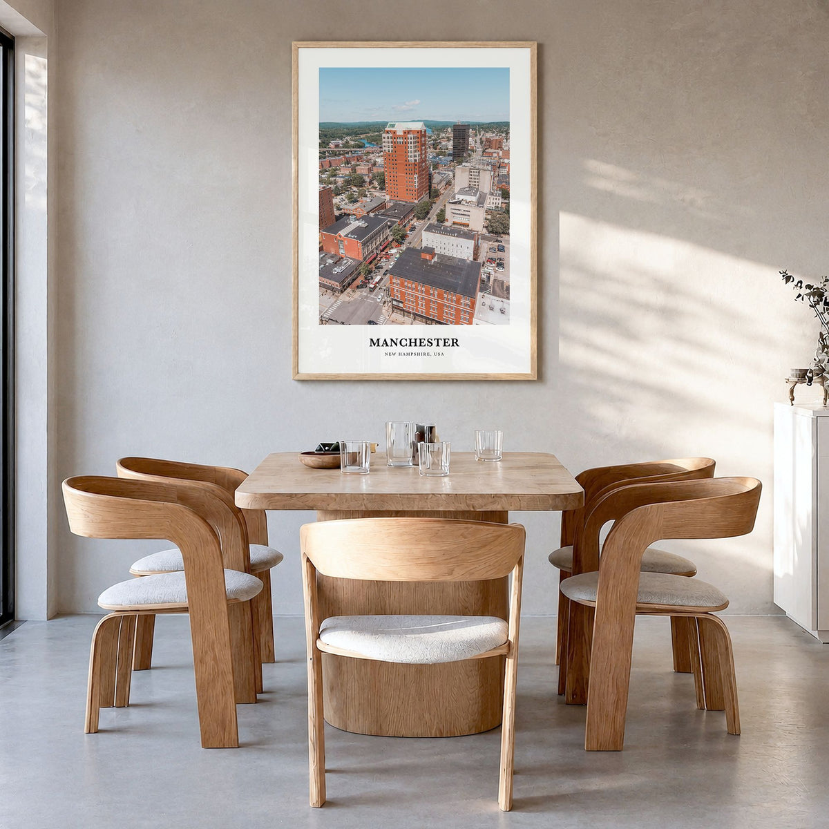 Manchester, New Hampshire Classic Poster in a natural wood frame, hanging in a dining room