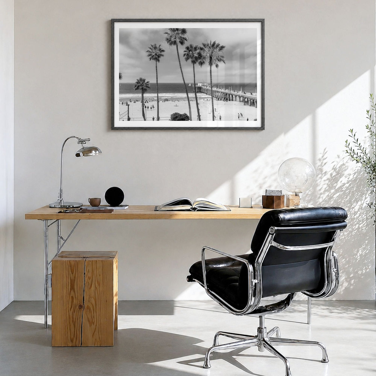 Manhattan Beach Photo Poster in a black wood frame, hanging in a bright home office, white border