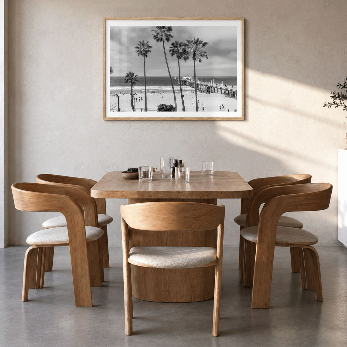 Manhattan Beach Photo Poster in a natural wood frame, hanging in a dining room, white border