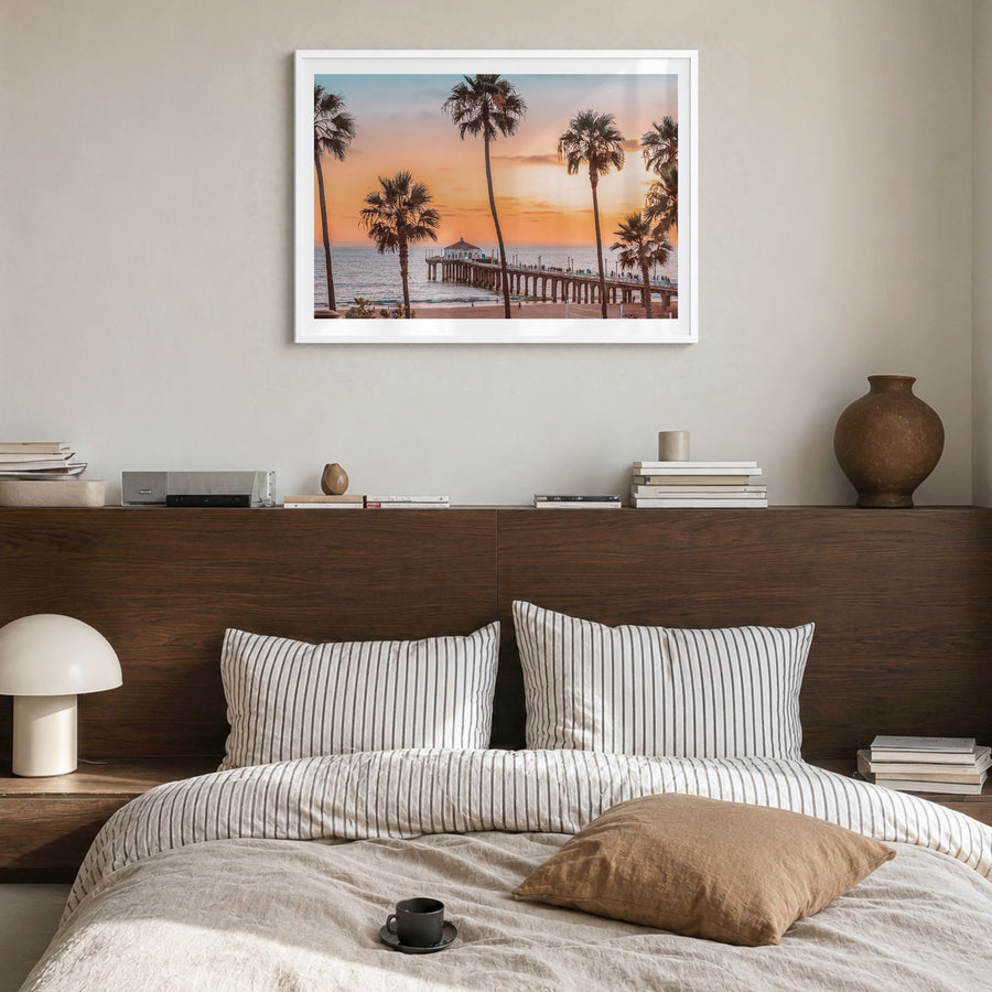 Manhattan Beach Photo Poster in a white wood frame, hanging in a bedroom, white border