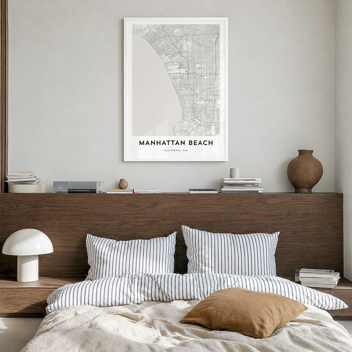 Manhattan Beach Map Poster in a white wood frame, hanging in a bedroom