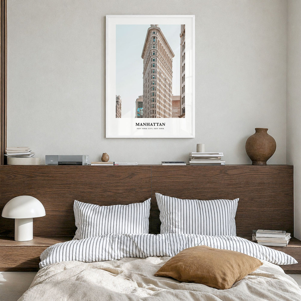 Manhattan Classic Poster in a white wood frame, hanging in a bedroom