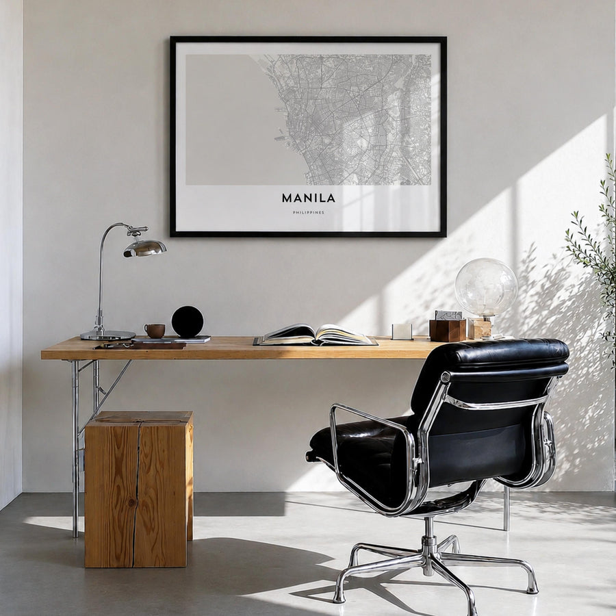 Manila black & white map poster of Philippines – horizontal wall art in black wood frame, hanging on wall