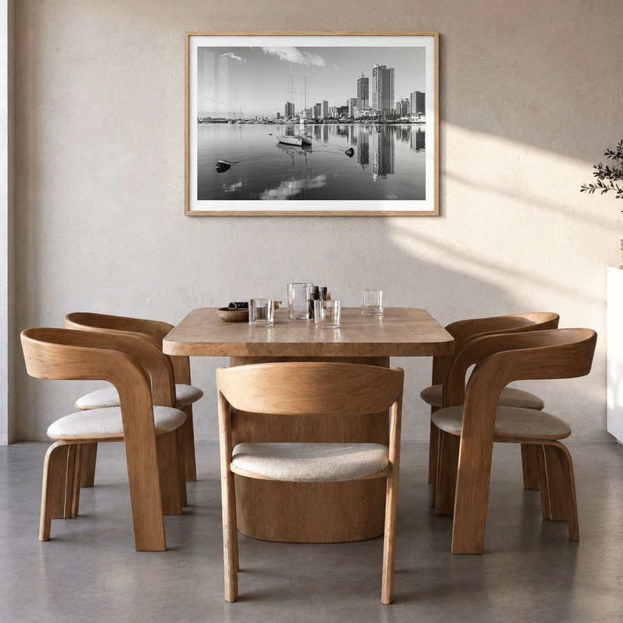 Manila Photo Poster in a natural wood frame, hanging in a dining room, white border