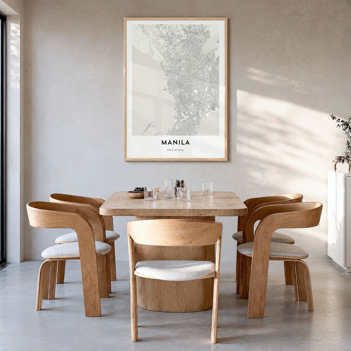 Manila Map Poster in a natural wood frame, hanging in a dining room