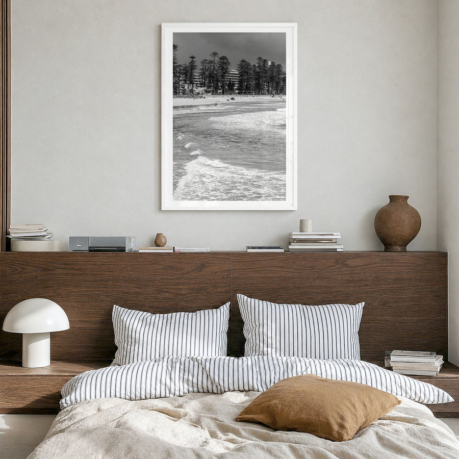 Manly Beach Photo Poster in a white wood frame, hanging in a bedroom, white border