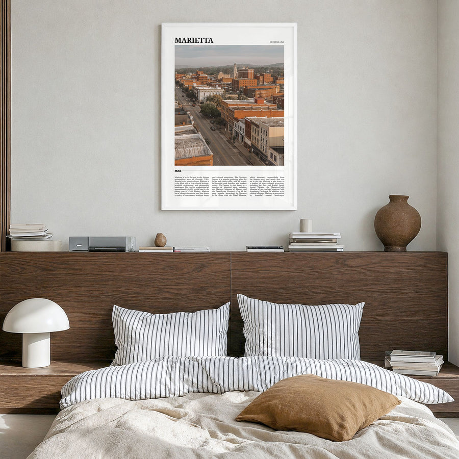 Marietta Travel Poster in a white wood frame, hanging in a bedroom